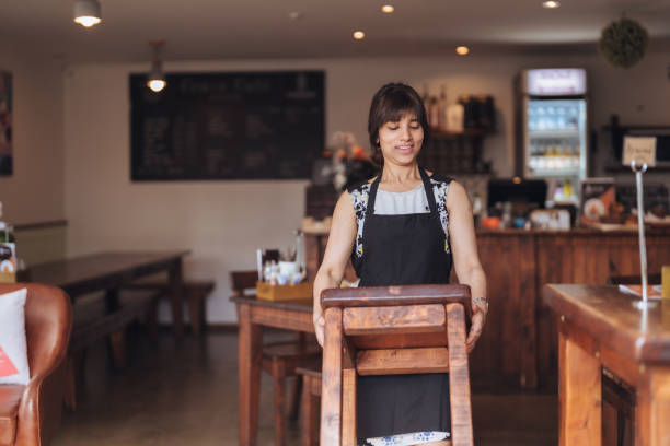 Small business owner setting up their café for the day