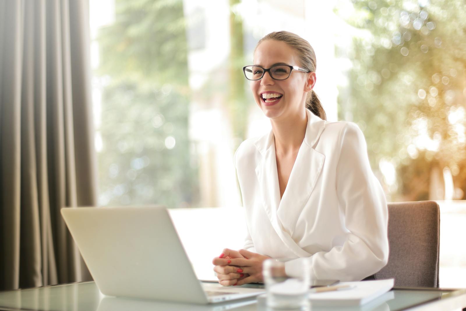 Small business owner working on a laptop in a bright office