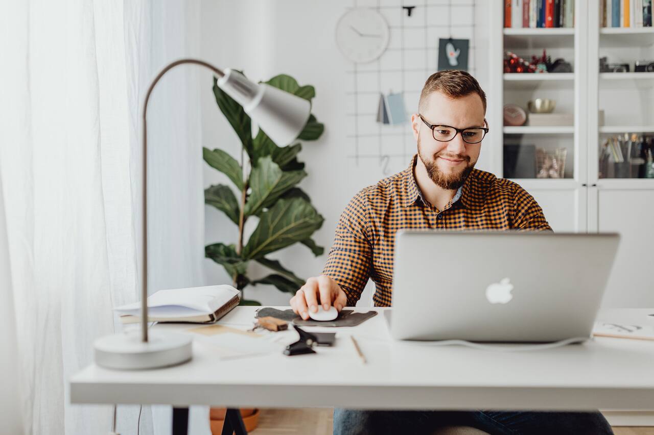Person at laptop in a warm home office researching modern search