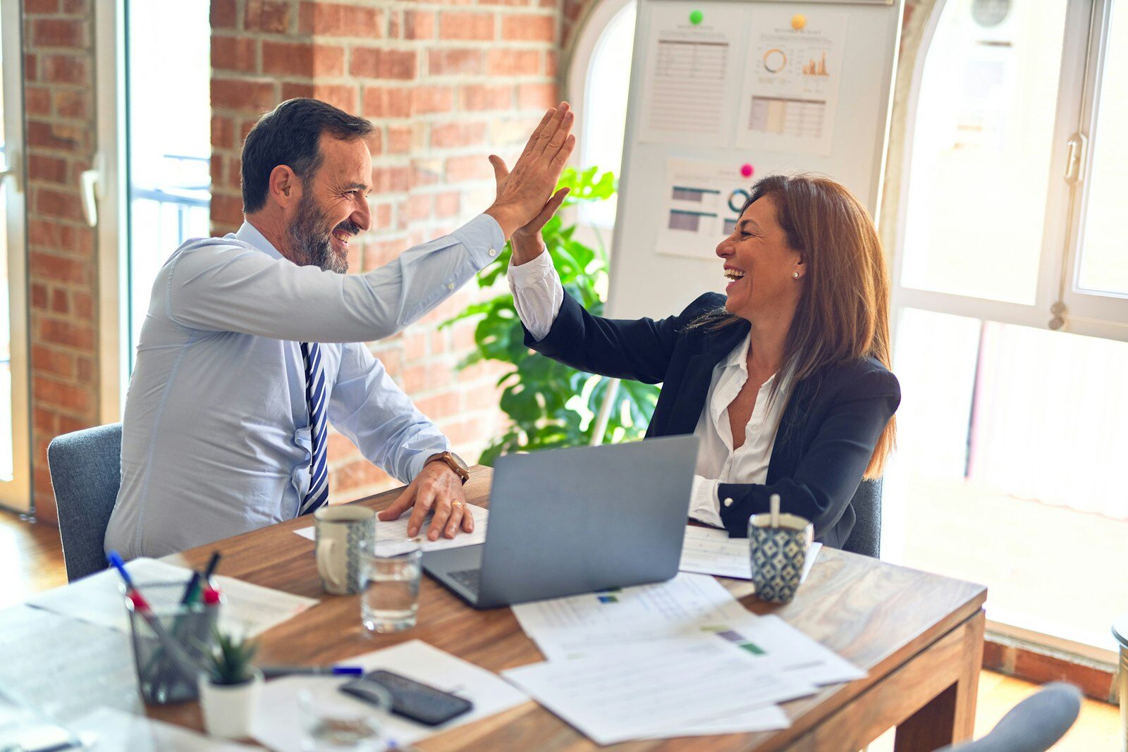 Business owner working confidently at their desk — Fairweb managed website hosting and support lets NZ small business owners focus on running their business
