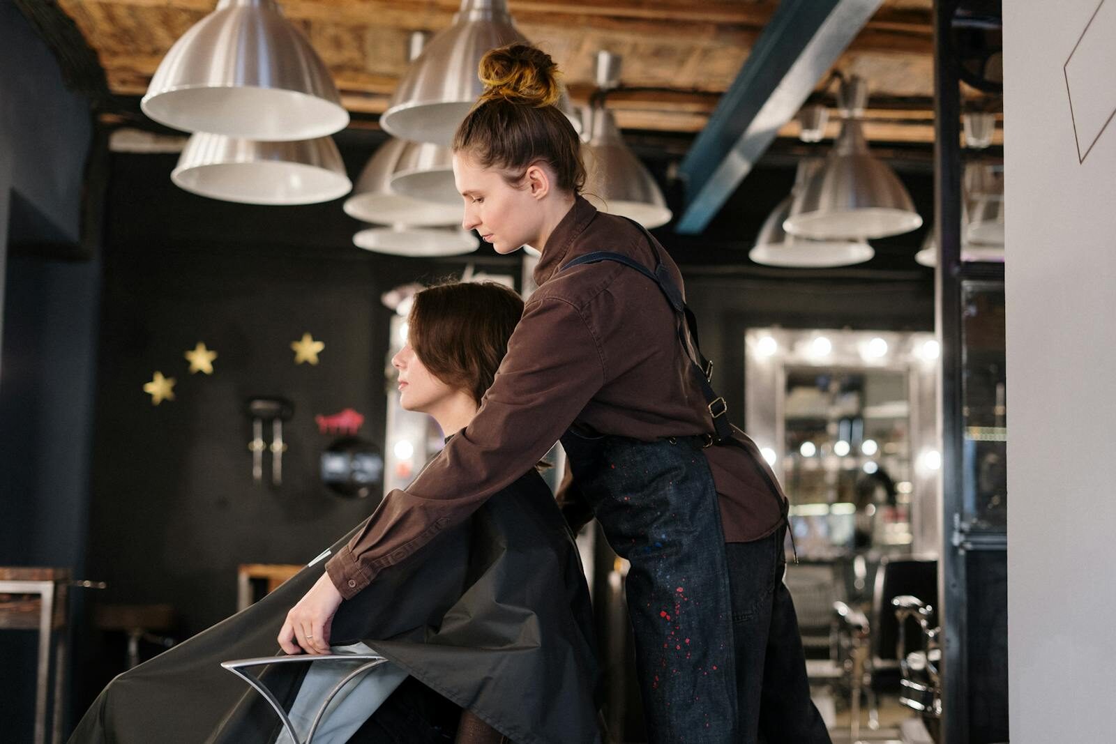 Hairdresser styling a client's hair in a modern salon