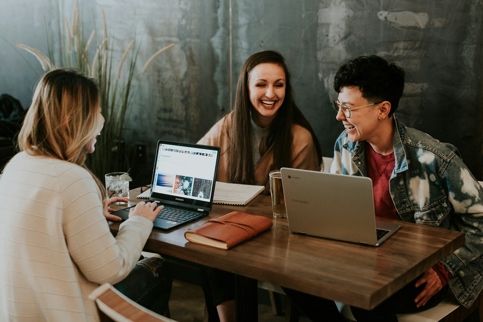 Happy small business owner reviewing their new website on a laptop