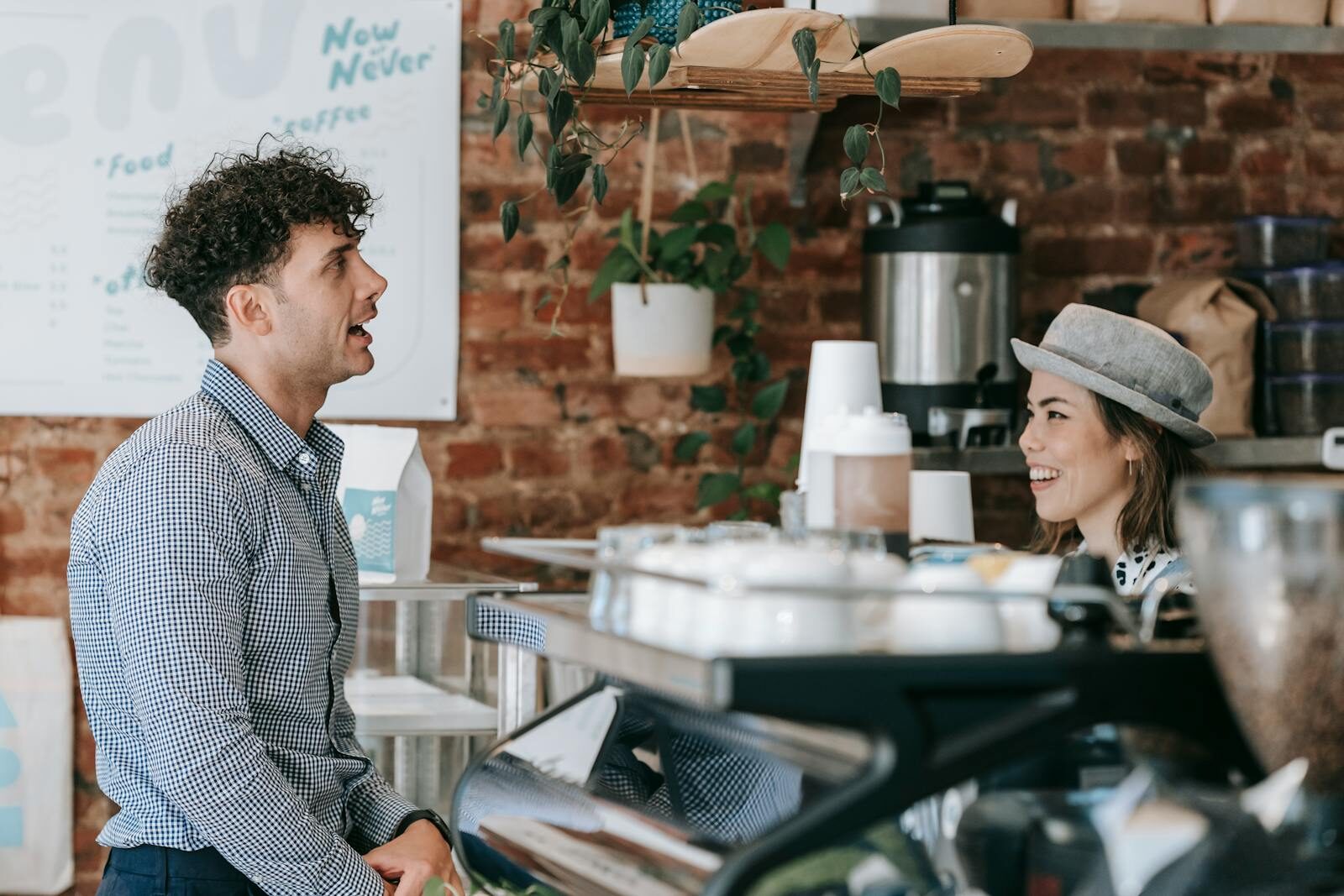 Barista serving a customer at a café counter